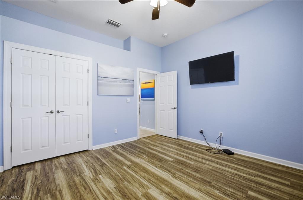 Unfurnished bedroom with wood finished floors, a closet, and ceiling fan