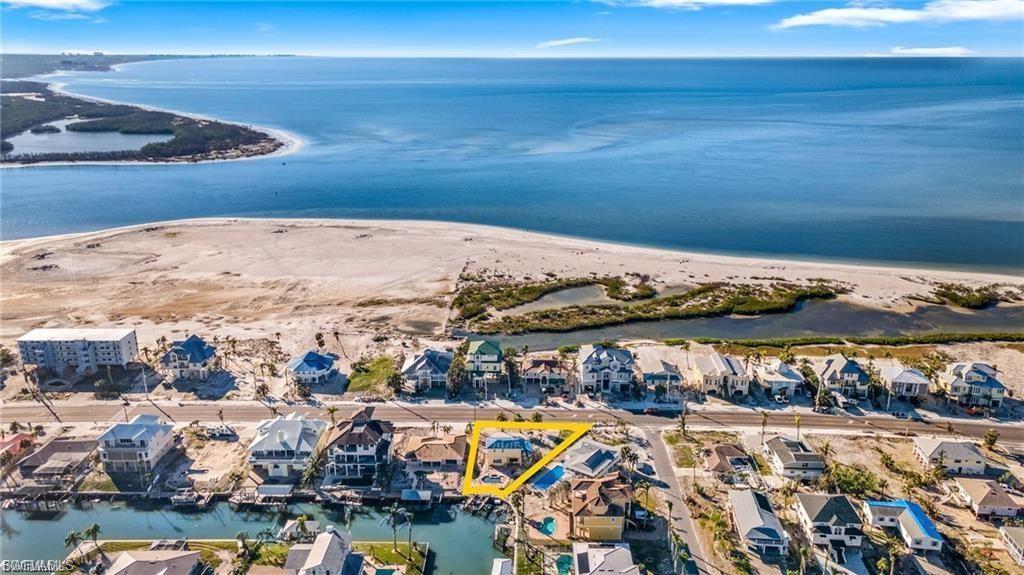 Aerial perspective of suburban area featuring a large body of water