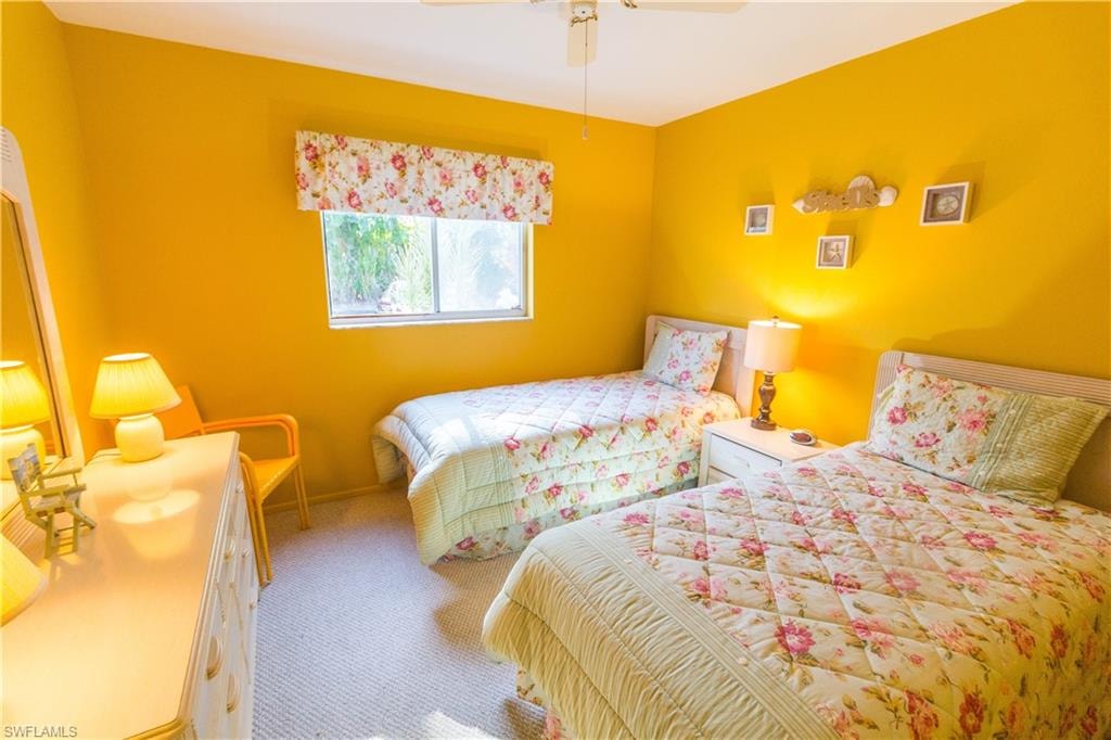 Bedroom featuring ceiling fan and carpet