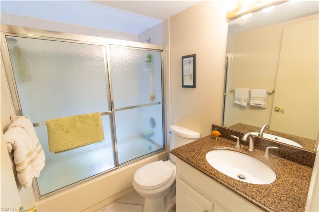 Bathroom with vanity, combined bath / shower with glass door, and tile patterned floors
