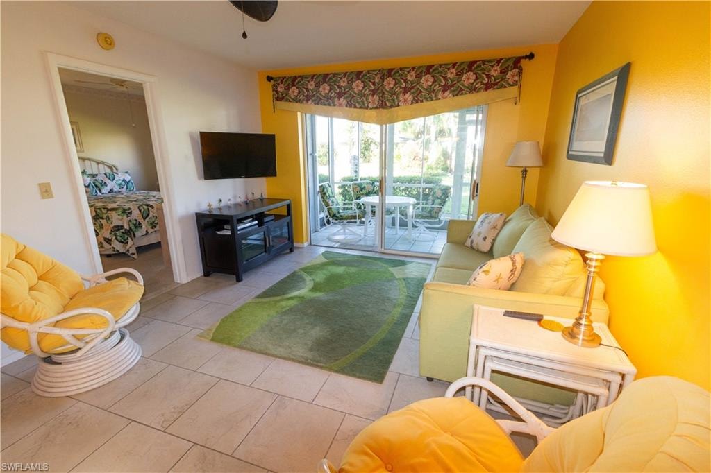 Living area with tile patterned flooring and ceiling fan