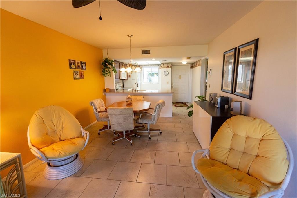 Dining room with light tile patterned flooring and ceiling fan