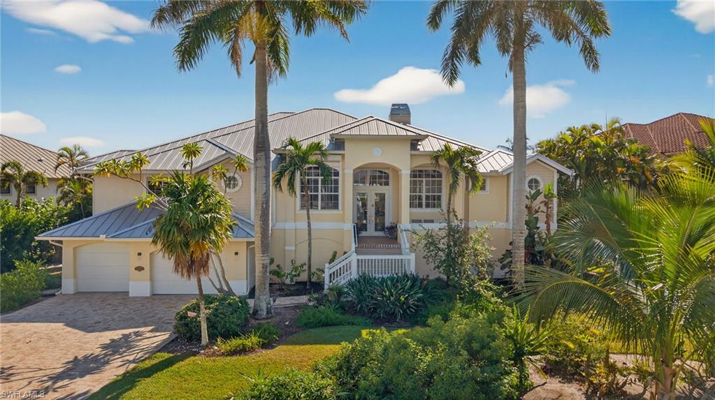 Mediterranean / spanish-style home with a standing seam roof, a metal roof, and a chimney