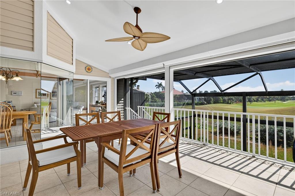 Sunroom / solarium with lofted ceiling, outdoor dining area, view of golf course, and ceiling fan