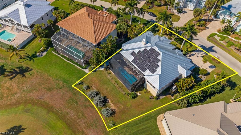 Aerial view of property and surrounding area with property parcel outlined