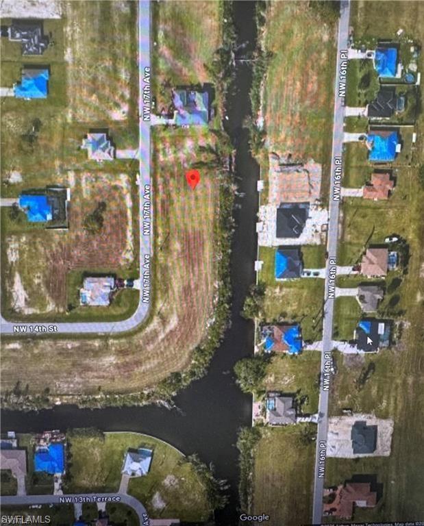 Aerial view of property's location with a nearby body of water