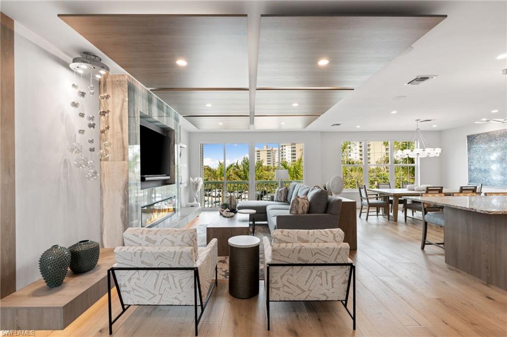 Living room featuring light wood-style floors, healthy amount of natural light, and recessed lighting
