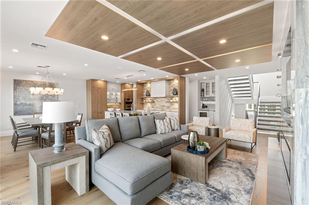 Living room featuring stairway, wood ceiling, light wood-type flooring, and recessed lighting