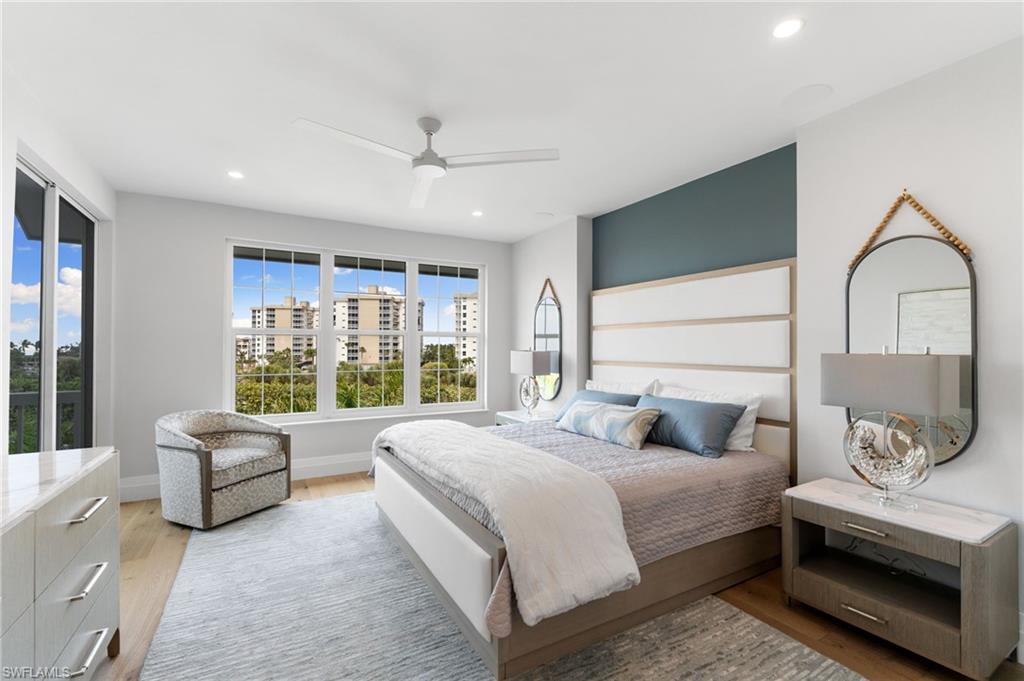 Bedroom with light wood finished floors, ceiling fan, and recessed lighting
