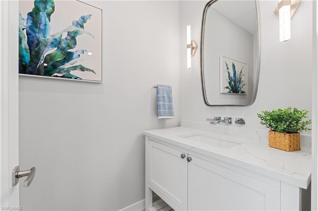 Bathroom featuring vanity and baseboards