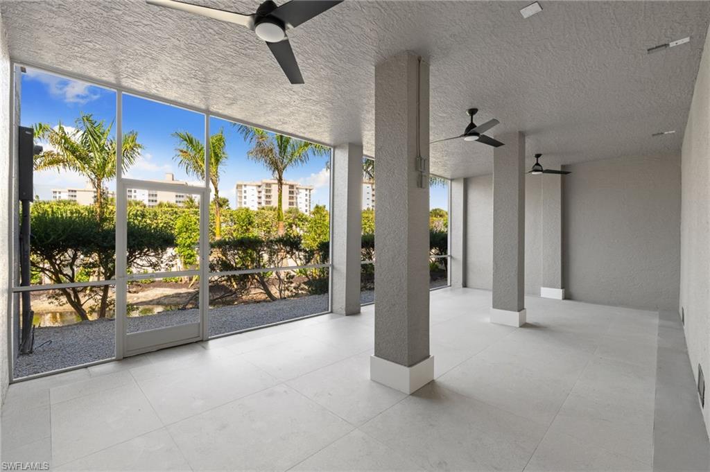 View of patio / terrace with ceiling fan and a sunroom