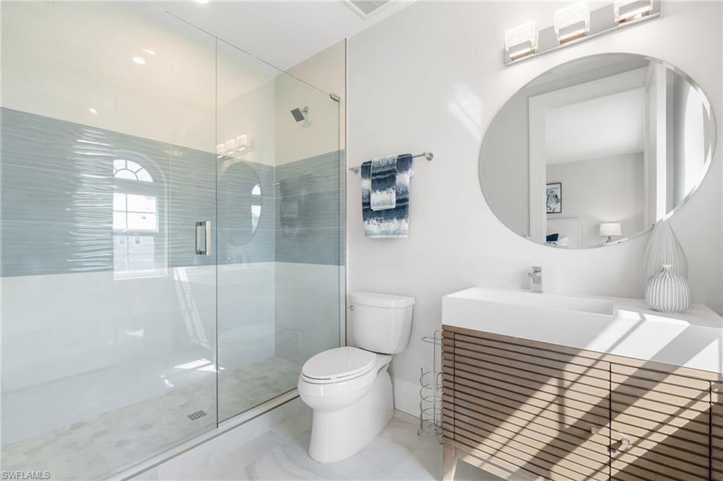 Bathroom featuring vanity and a stall shower
