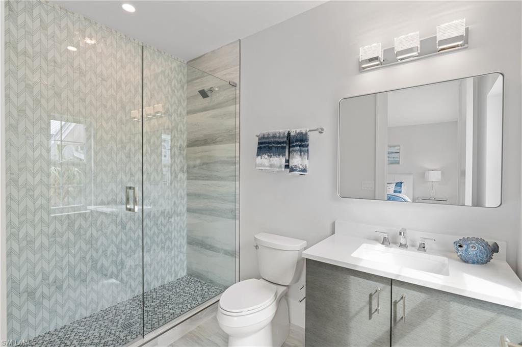 Bathroom featuring a stall shower and vanity
