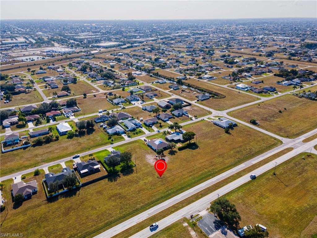 Aerial view of property's location with nearby suburban area