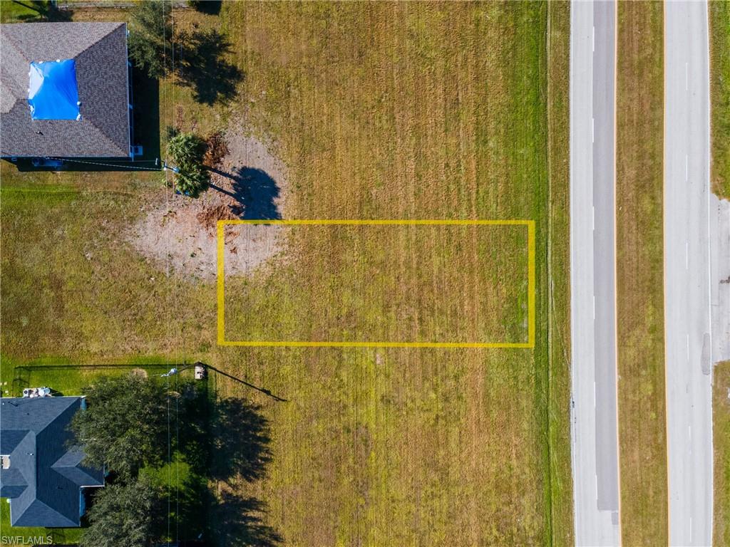 Aerial view of property and surrounding area with property parcel outlined