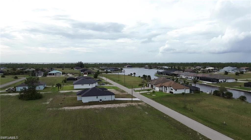 Aerial view of residential area featuring a large body of water
