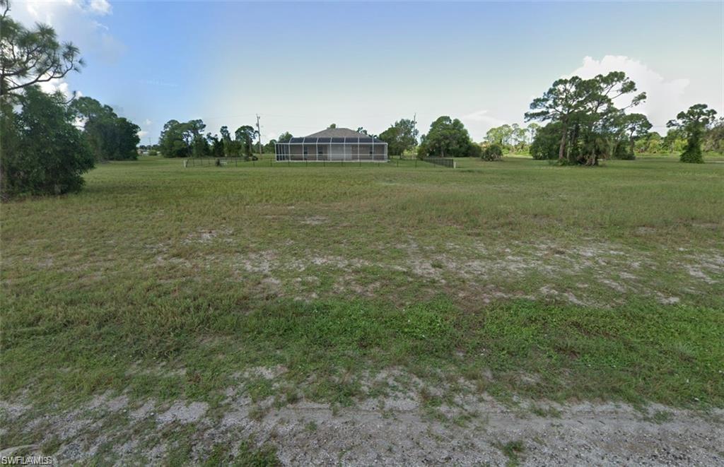 View of green lawn featuring a rural view