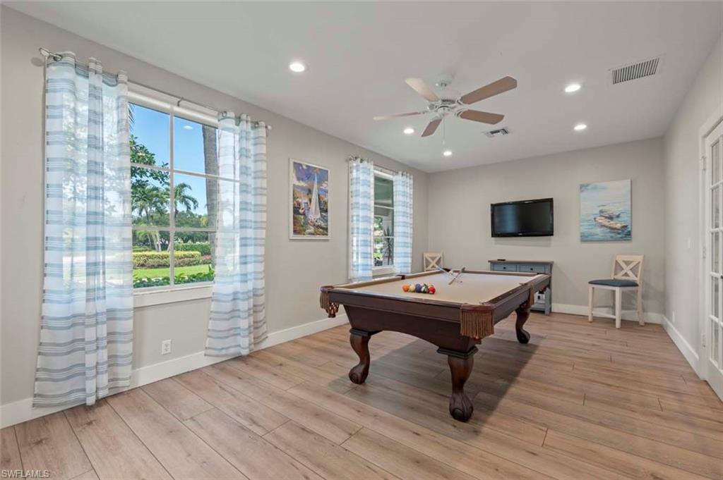 Playroom with billiards table, plenty of natural light, light wood-style floors, recessed lighting, and a ceiling fan
