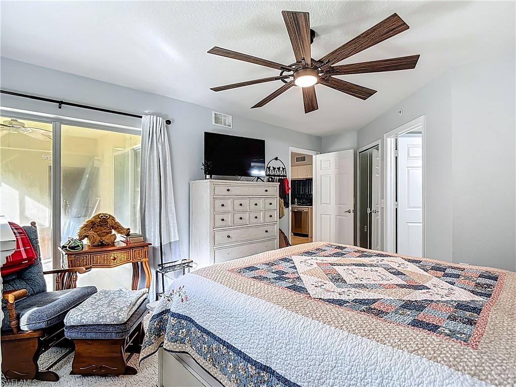 Carpeted bedroom with ceiling fan
