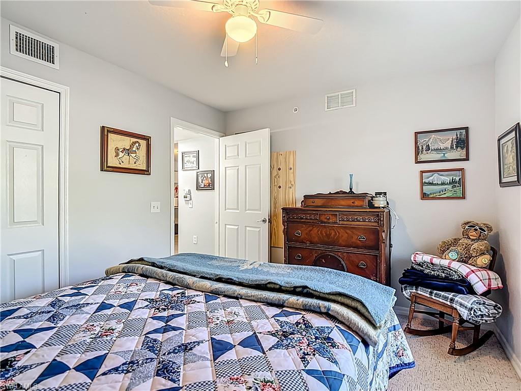Bedroom with a ceiling fan and carpet floors