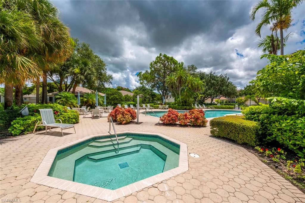 Community pool featuring a community hot tub and a patio area