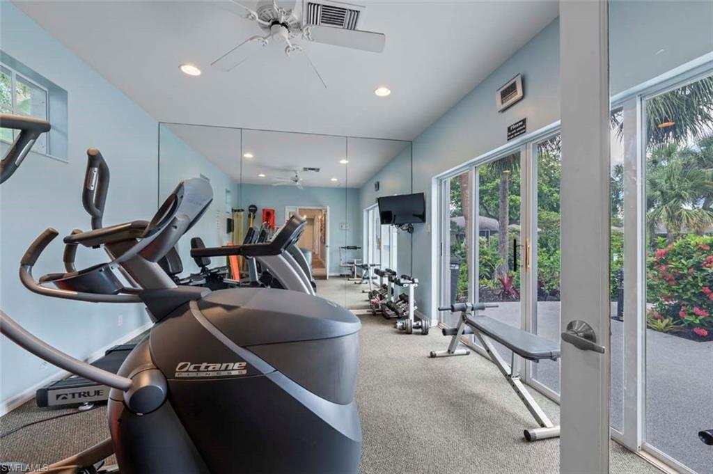 Gym with ceiling fan and recessed lighting