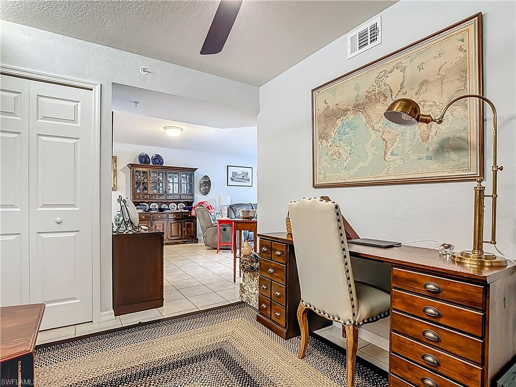 Office space with light tile patterned floors, a textured ceiling, and ceiling fan