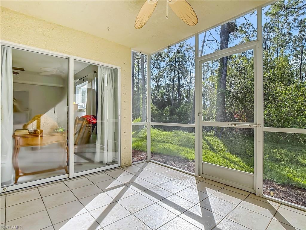 Unfurnished sunroom featuring ceiling fan