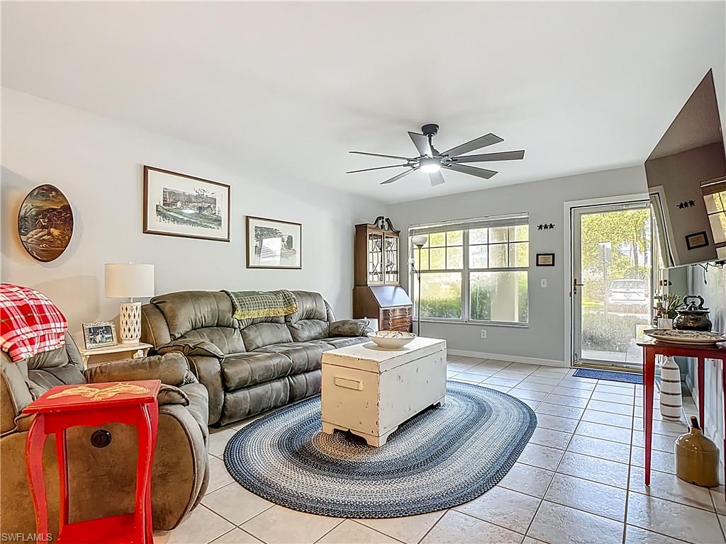 Living area with light tile patterned flooring and a ceiling fan