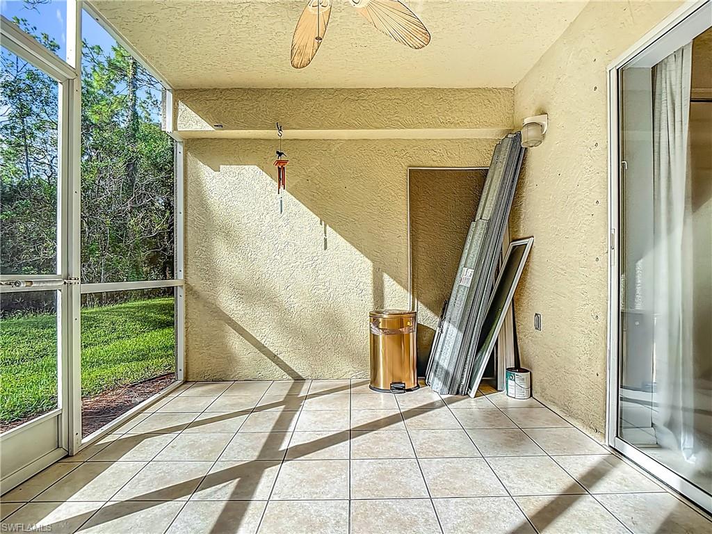 Unfurnished sunroom featuring ceiling fan
