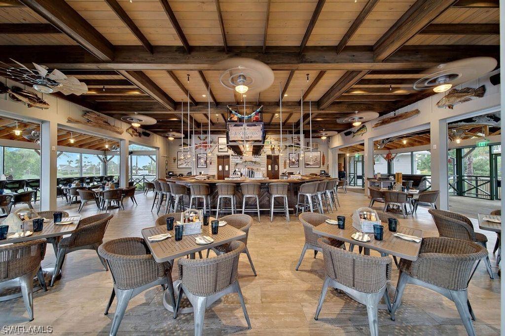 Dining space featuring healthy amount of natural light and a wood ceiling with exposed beams