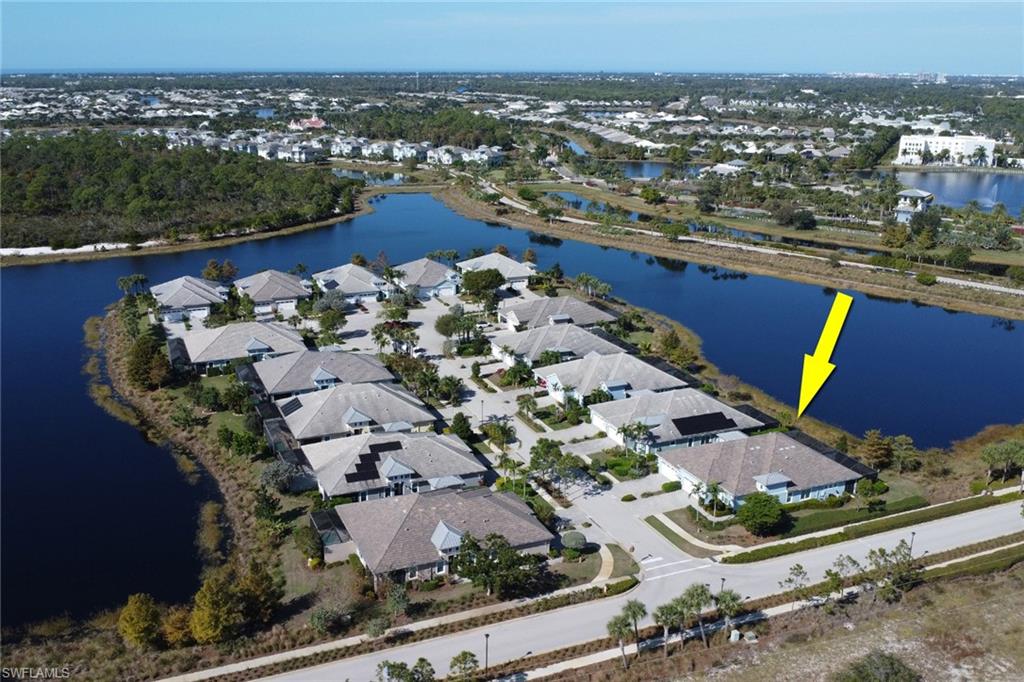 Aerial view of property and surrounding area featuring a large body of water