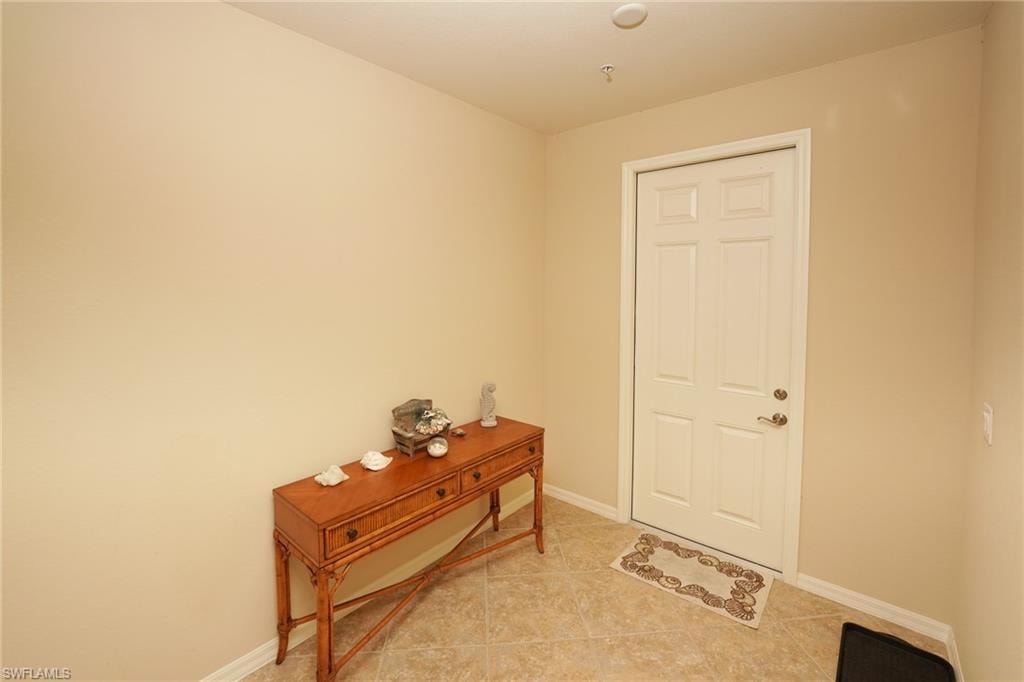 Tiled foyer entrance featuring baseboards