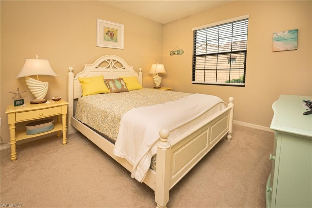 Carpeted bedroom with baseboards