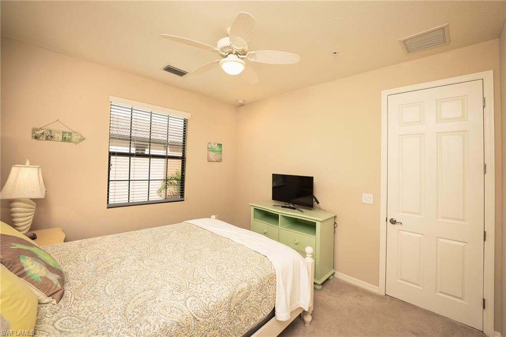 Bedroom featuring light carpet and ceiling fan