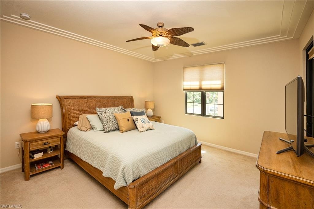 Bedroom with a ceiling fan and carpet flooring