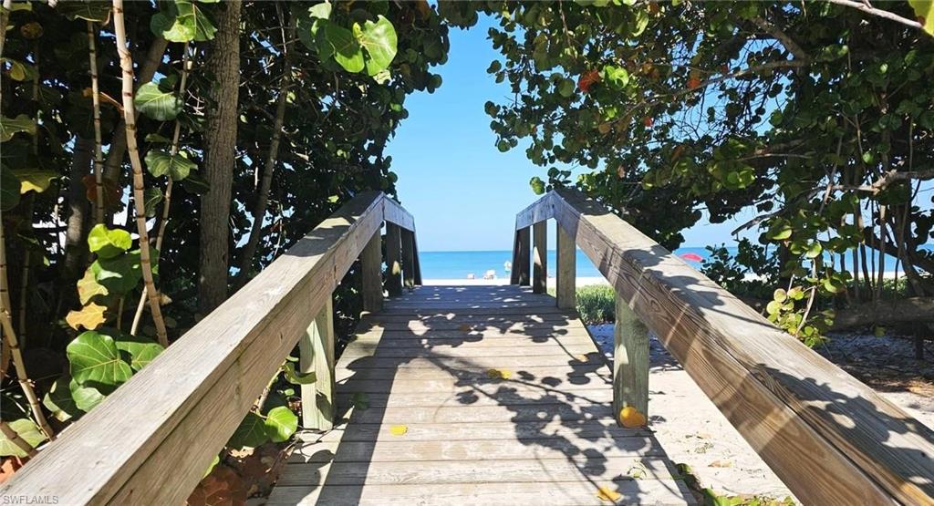 View of property's community featuring view of water and beach