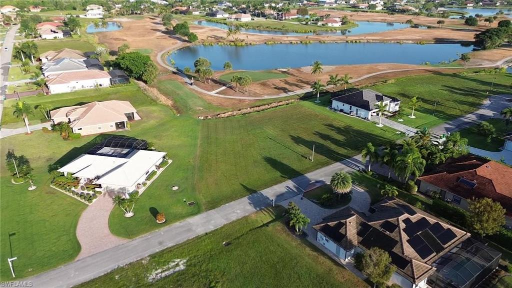 Aerial view of property's location featuring a large body of water and nearby suburban area