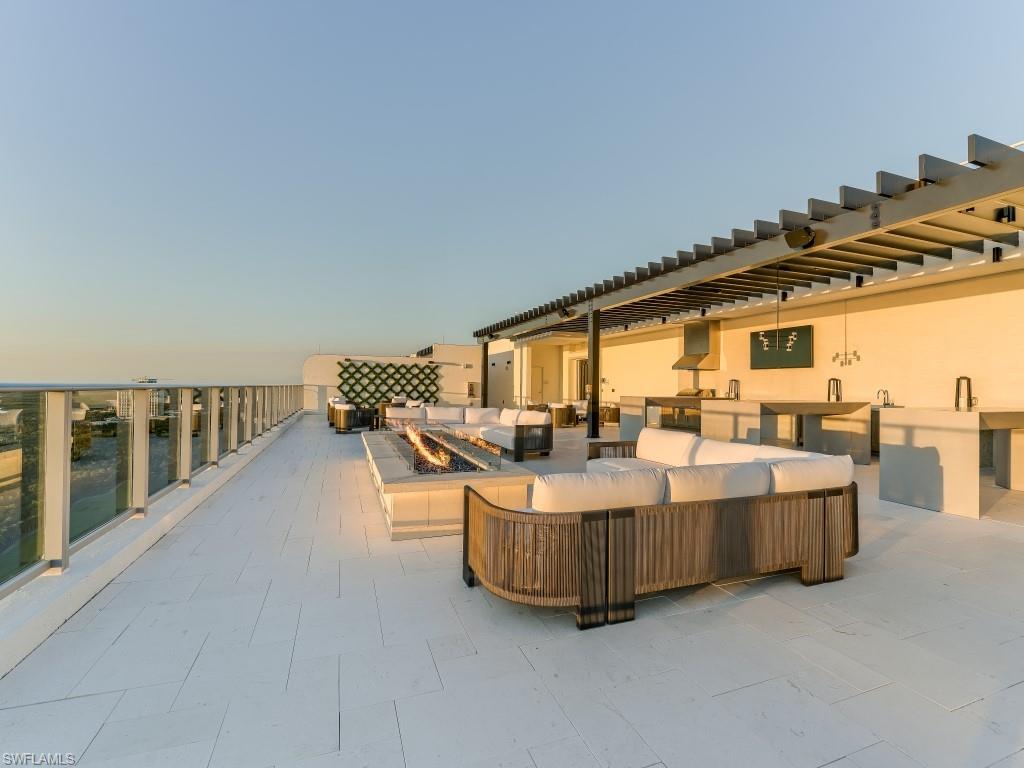View of patio with an outdoor living space with a fire pit