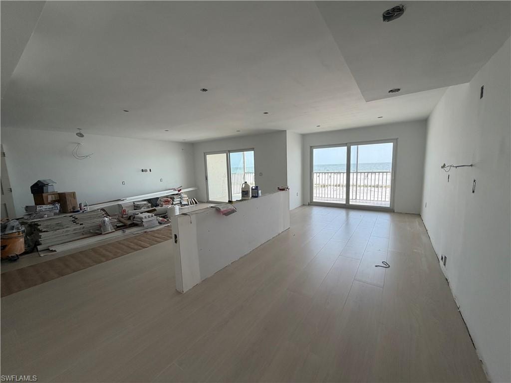 Living/Kitchen space. features 2 sets of slider doors accessing beachfront balcony. construction progress