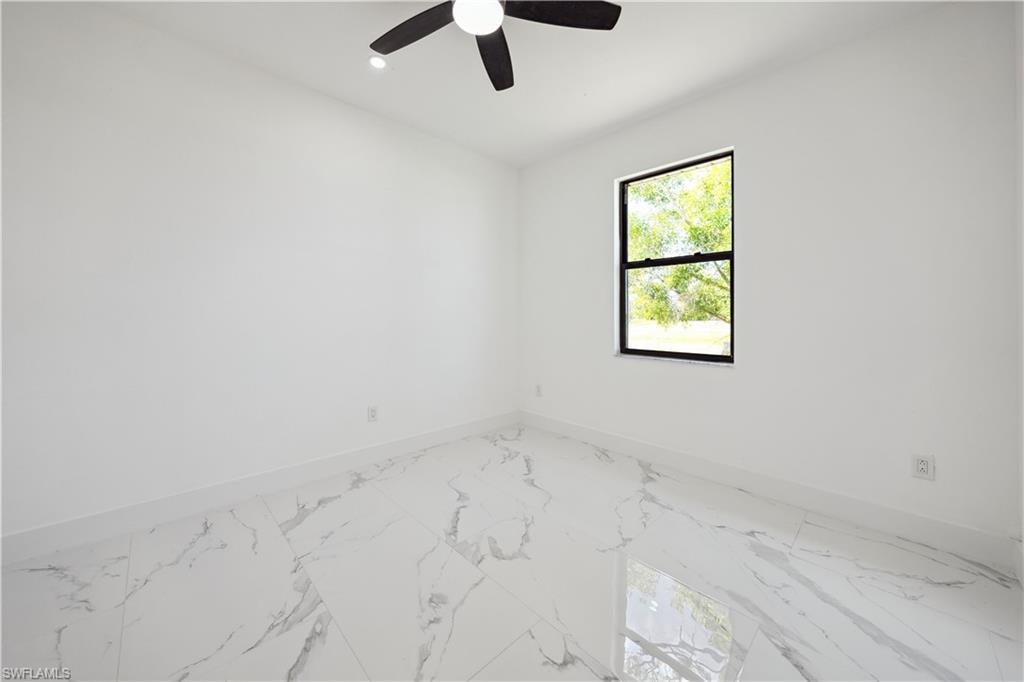 Empty room with marble finish floors, ceiling fan, and recessed lighting