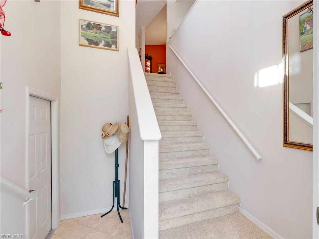 Stairway featuring baseboards and tile patterned flooring
