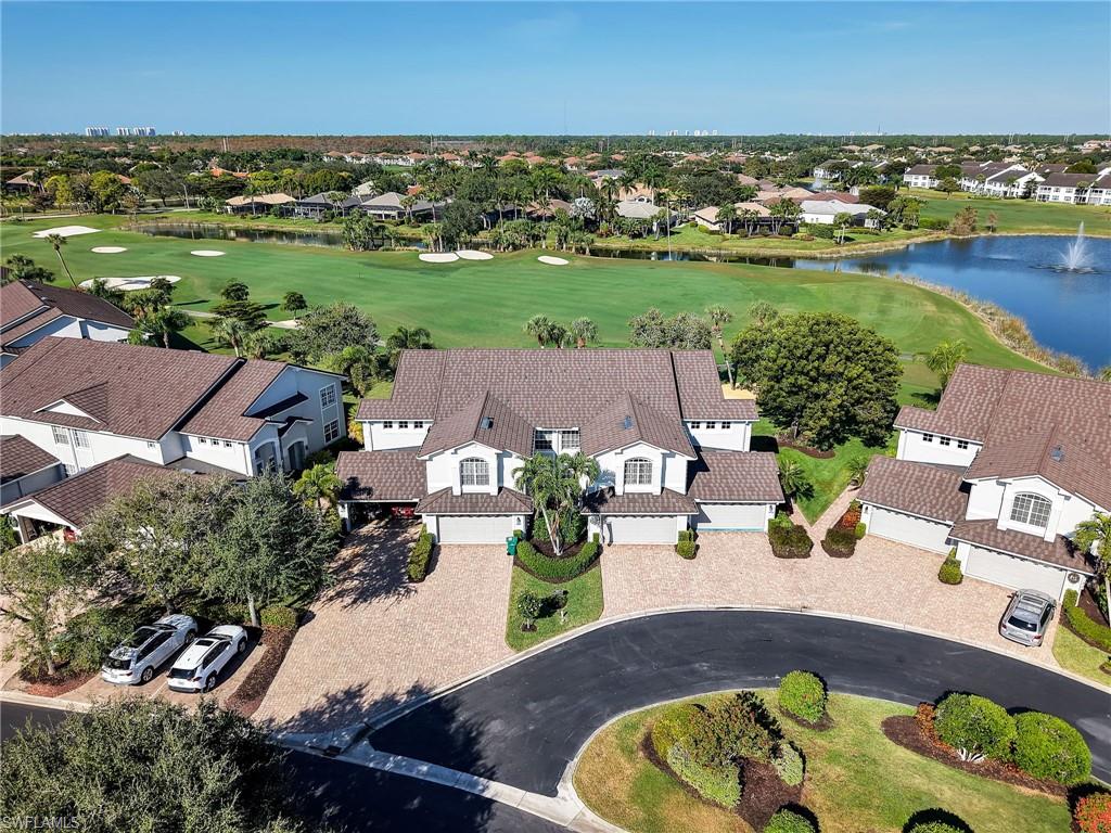Aerial view features golf course and a lake