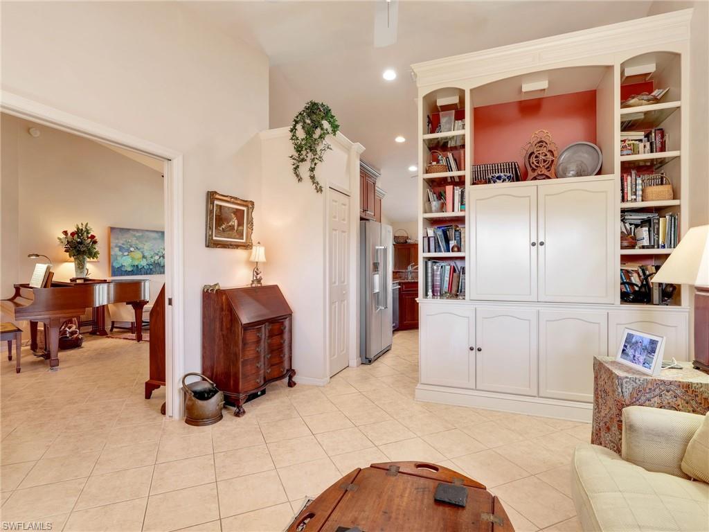 Flex/Den/Office area featuring light tile patterned flooring, pocket doors, built in cabinetry, and recessed lighting