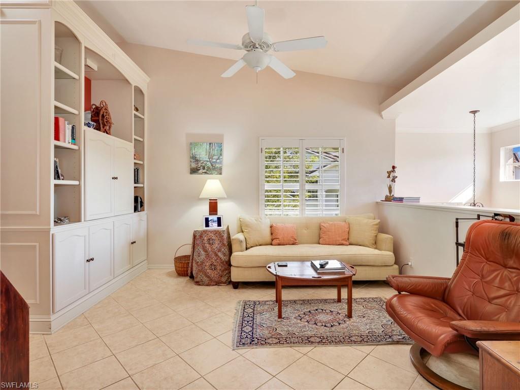 Flex space w/ lofted ceiling, a ceiling fan, and light tile patterned floors