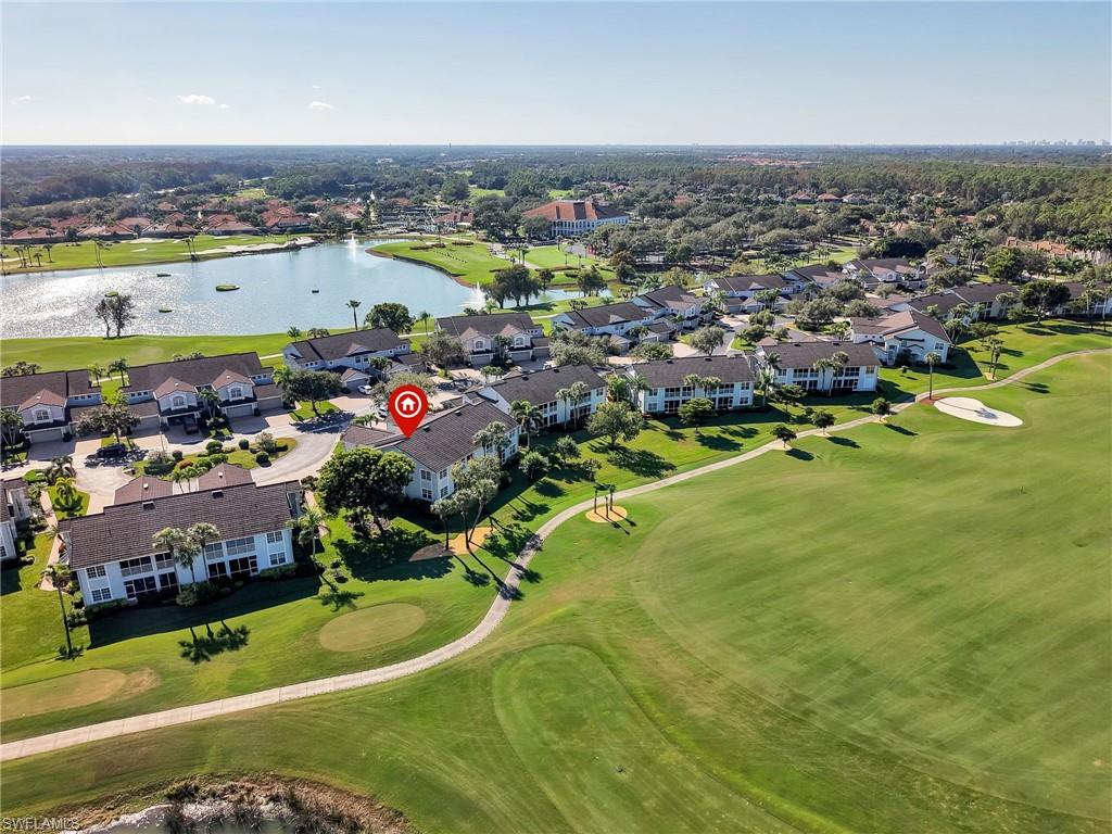 Aerial view of residential area with a golf course and a nearby body of water