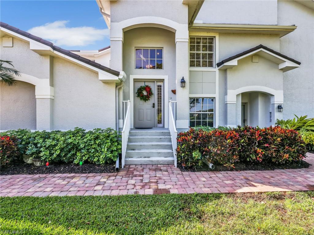 Property entrance featuring stucco siding