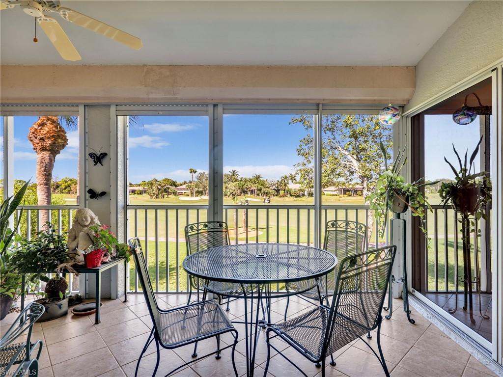 Sunroom with golf course view, tile patterned flooring, and healthy amount of natural light, sunset views, accesses to kitchen, living, and primary suite