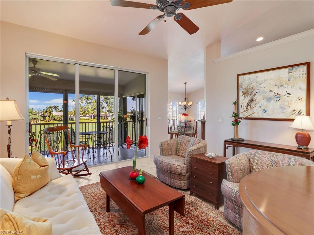 Living area with ceiling fan, open to lanai, and tile patterned floors
