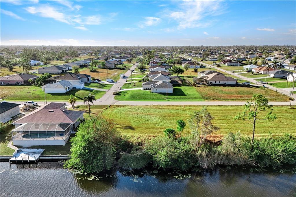 Aerial perspective of suburban area featuring a large body of water
